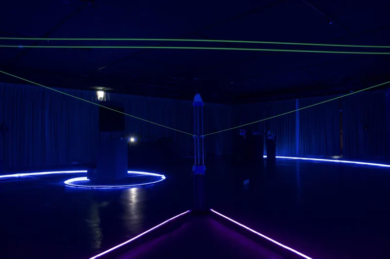 Exhibition space with blue light and circular installations