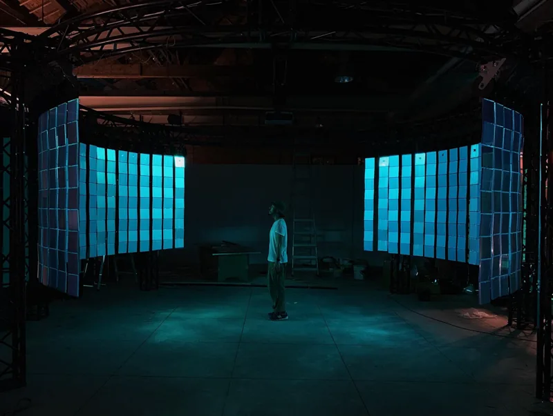Performance space filled with cyan light