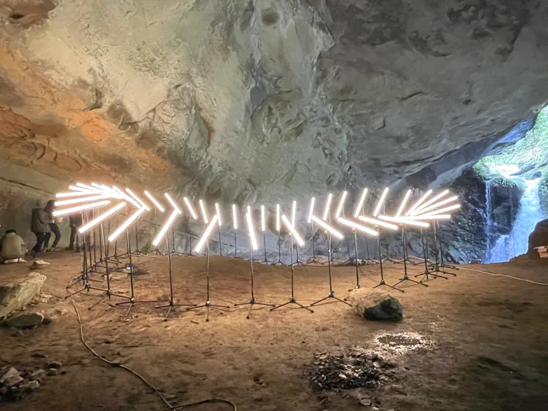 Linear light installation against a rock wall