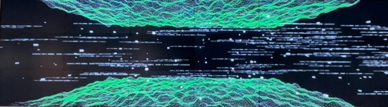 Moving visuals with green waveforms and white particles