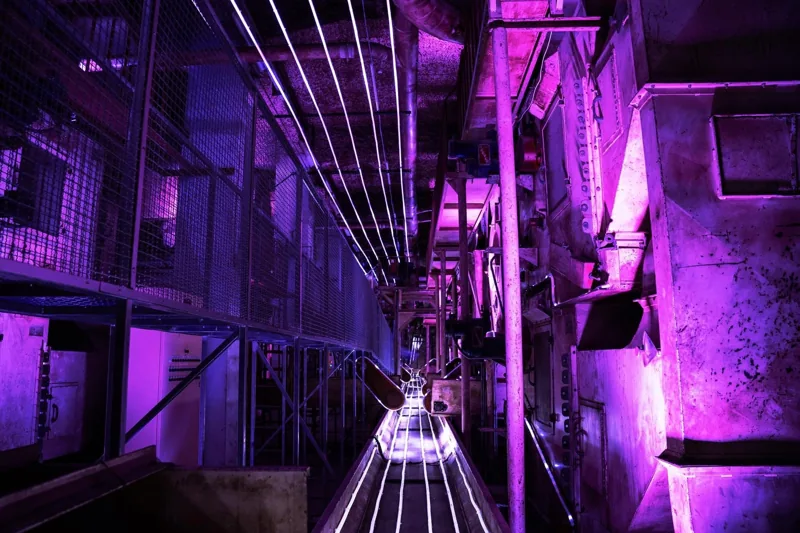 Purple linear light in an industrial space
