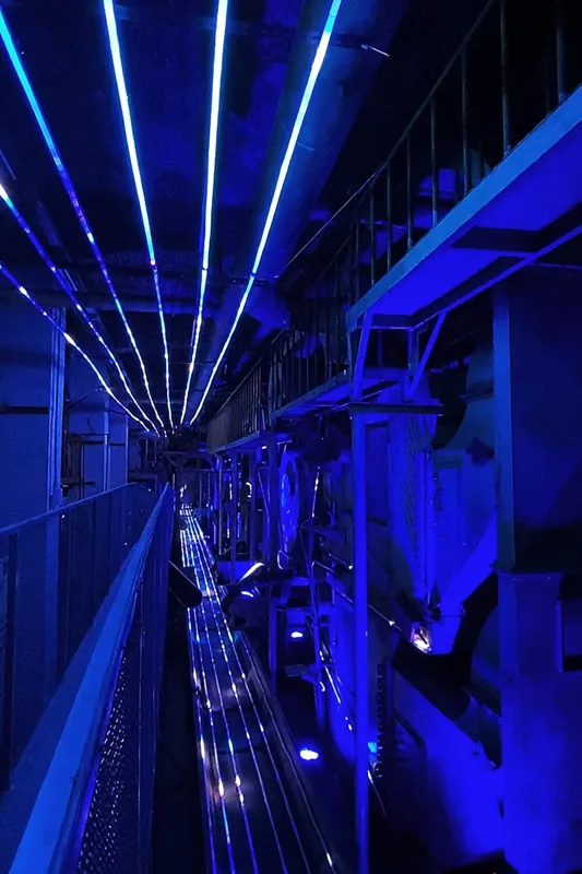 Blue light extending through an industrial space