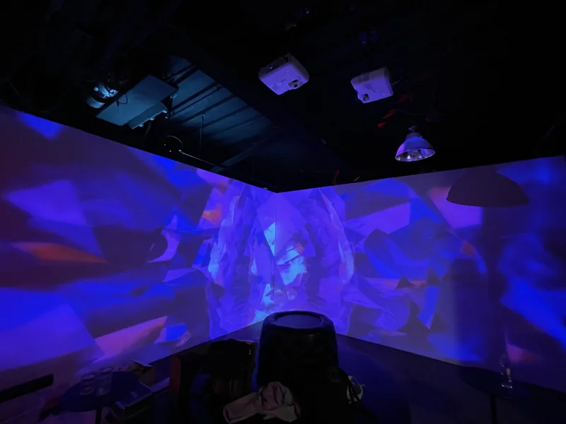 Blue and purple projection surrounding a space